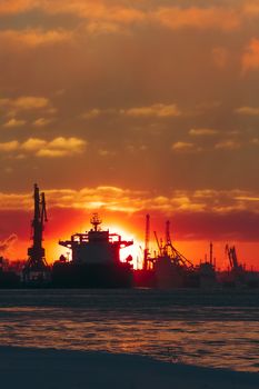 Colorful winter sunrise against the cargo port