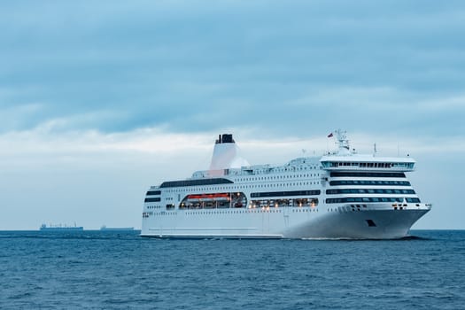White cruise liner. Passenger ferry moving in still water