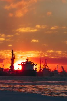 Colorful winter sunrise against the cargo port