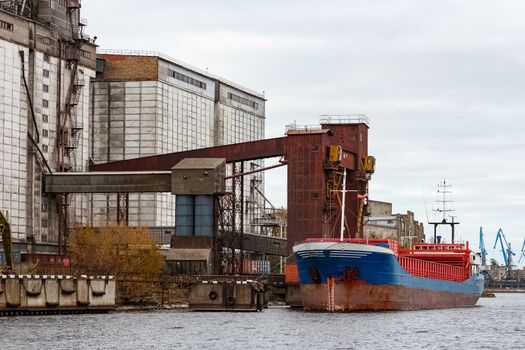 Blue cargo ship loading in the port of Riga, Europe