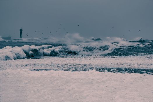 Big waves at the sea in stormy weather. Toned dark blue