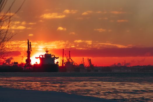 Colorful winter sunrise against the cargo port