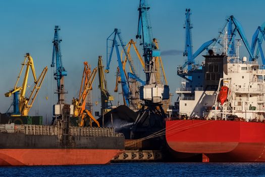 Red cargo ship loading in the port of Riga, Europe