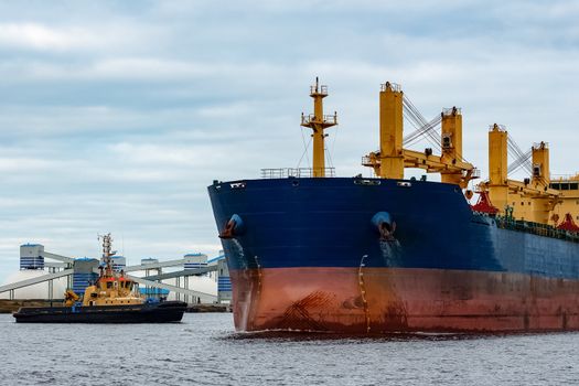 Blue cargo ship entering the port of Riga, Europe