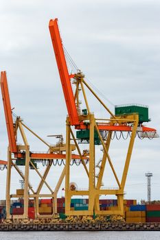 Yellow cargo cranes in the port of Riga, Europe