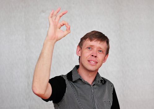 Gesture attractive middle aged man isolated on neutral background.