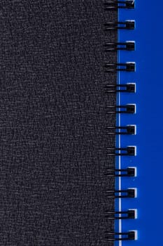 Blue notepad on a spiral on a black background