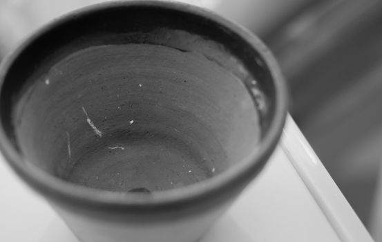 BLACK AND WHITE PHOTO OF CLOSE-UP OF CLAY POT TEXTURE
