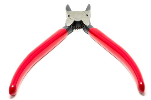 Red open and handled pliers  on a white background.Tools series.