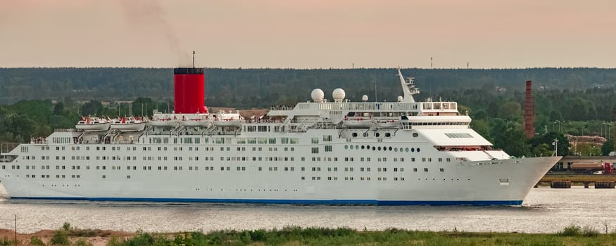 White passenger ship. Cruize ferry sailing past old town