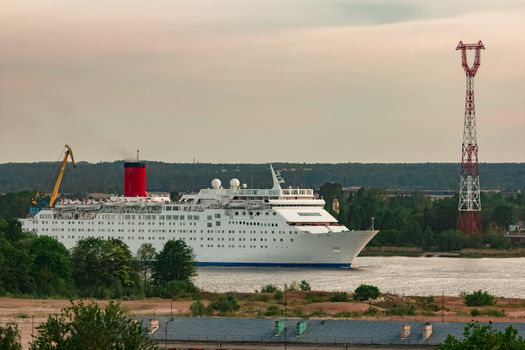White passenger ship. Cruize ferry sailing past old town