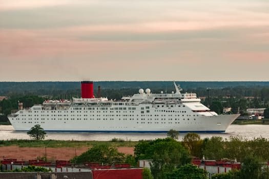 White passenger ship. Cruize ferry sailing past old town