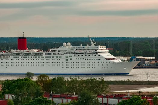 White passenger ship. Cruize ferry sailing past old town
