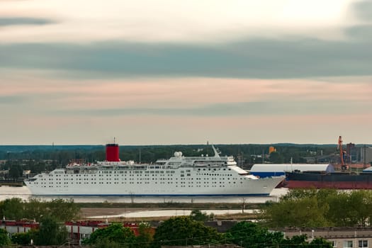 White passenger ship. Cruize ferry sailing past old town