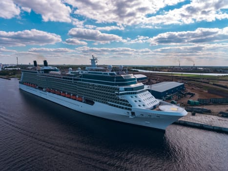 Big white passenger ship moored at the cargo port