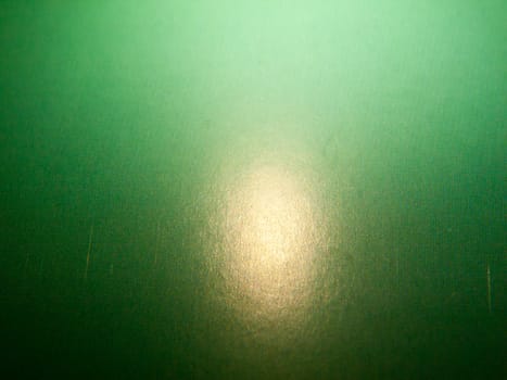 a retro green textured surface with light orb; England; UK