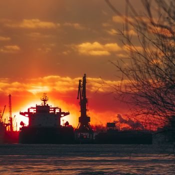 Colorful winter sunrise against the cargo port