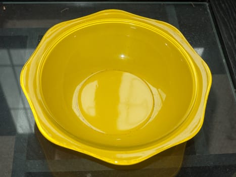 a yellow empty bowl sitting on table; England; UK