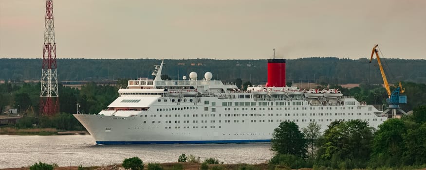 White passenger ship. Cruize ferry sailing past old town