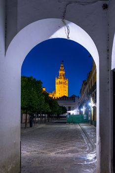 The Giralda bell tower lit up at night in Seville, Spain, Europe