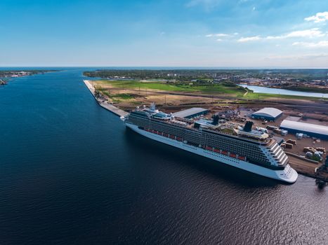 Big white passenger ship moored at the cargo port