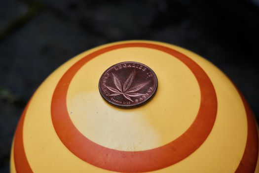 Brass cannabis coin with marijuana leaf. Legalize it. Sativa.