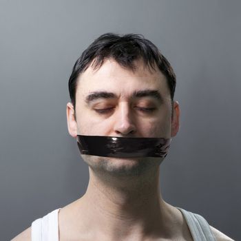 man's portrait with black duck tape on his face