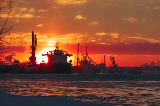 Colorful winter sunrise against the cargo port