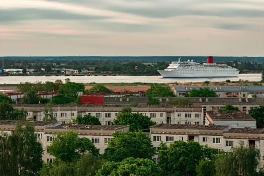 White passenger ship. Cruize ferry sailing past old town