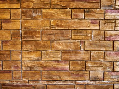 Details of decorative hand craft stone wall in light earth colors