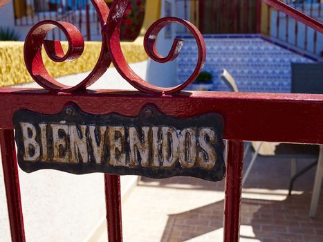 Welcome sign in Spanish Bienvenidos on a gate of a house Spain
