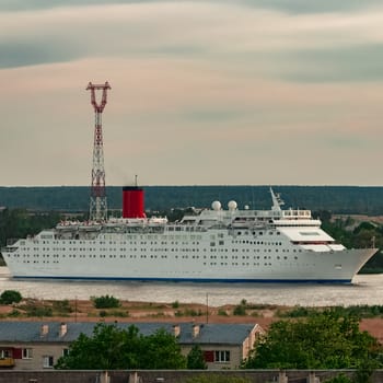 White passenger ship. Cruize ferry sailing past old town