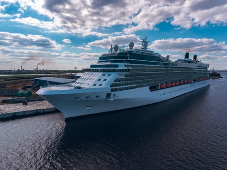 Big white passenger ship moored at the cargo port