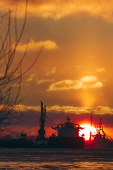 Colorful winter sunrise against the cargo port