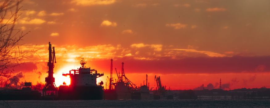 Colorful winter sunrise against the cargo port