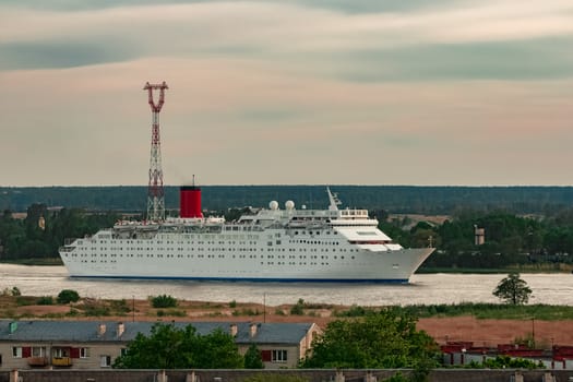 White passenger ship. Cruize ferry sailing past old town