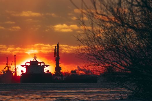 Colorful winter sunrise against the cargo port