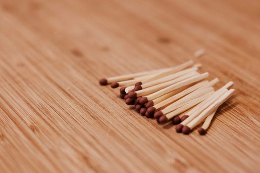 Brown small matches on the wooden board. Close-up photography. Wooden concept.