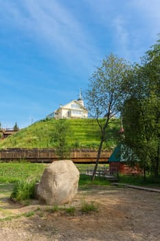 Sacred stone on the background of the church, Radonezh, font, Golden Ring, Russia