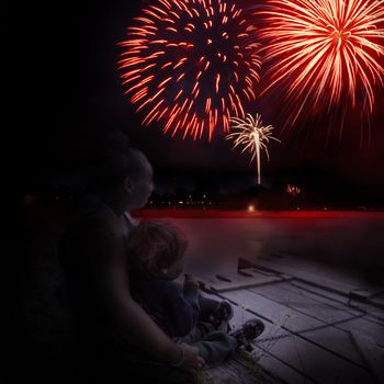 A loving embrace of this closeup view of mother and son enjoying the celebration during the fireworks display.
