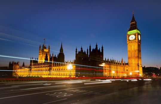 Big Ben and London at night with the lights of the cars passing by after rain, the most prominent symbols of both London and England