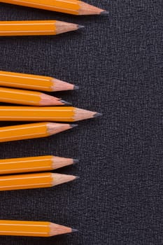 set of pencils on black background, closeup, macro