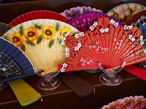 Typical traditional hand made decorative Spanish fans in a market display Spain