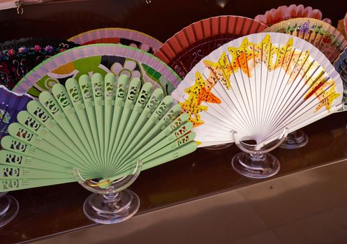 Typical traditional hand made decorative Spanish fans in a market display Spain