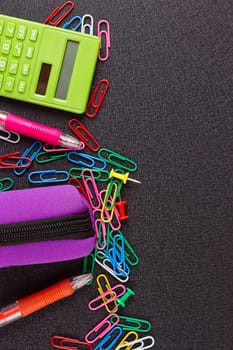 School supplies on blackboard background ready for design