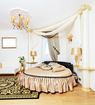 Cassical golden bedroom interior with round bed