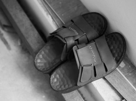 BLACK AND WHITE PHOTO OF MEN BROWN LEATHER SANDAL