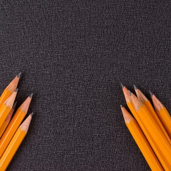 set of pencils on black background, closeup, macro