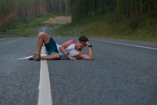 Man laying on the beauty road in mountain
