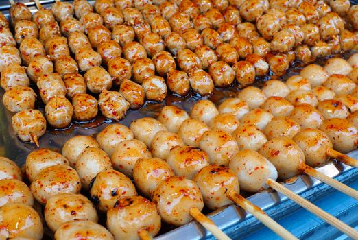 Pork balls with sweet spicy sauce for sale at street market in bangkok thailand.